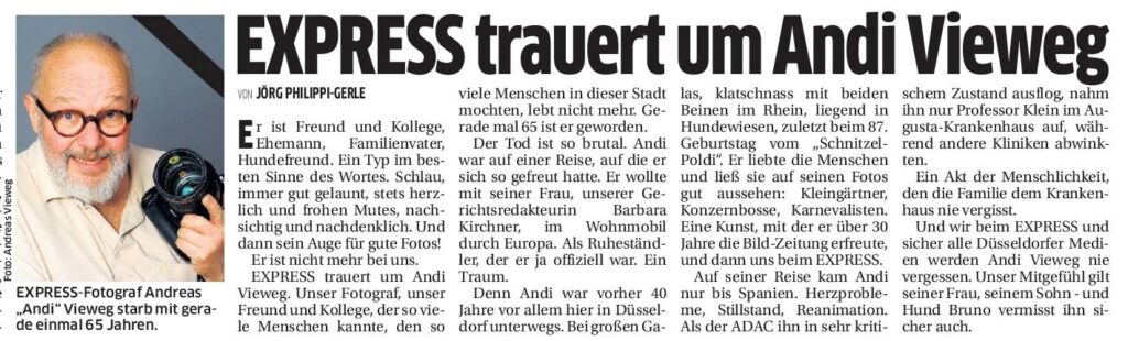 Traueranzeige für Andi Vieweg mit Blumen und Kerzen bei einer Gedenkveranstaltung.